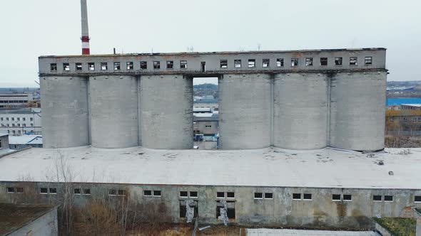 old abandoned factory with concrete pipes and broken windows. Aerial view. alt