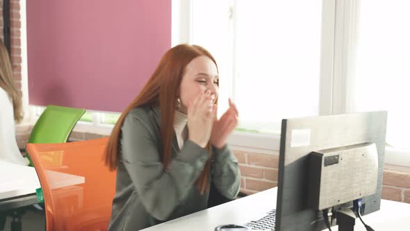 Redhaired Girl Manager Shows Various Happy Emotions Looking at the Screen of the Monitor