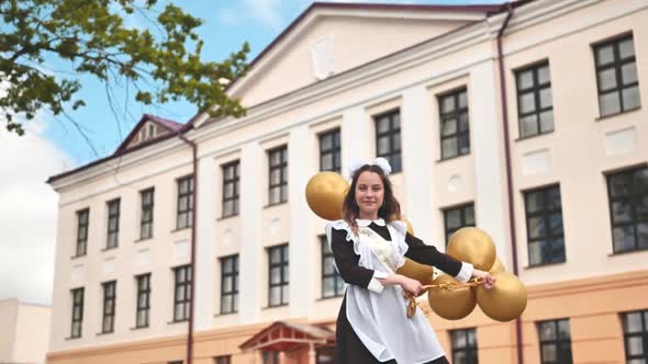 Happy Russian Schoolgirl with Balloons on Graduation Day alt