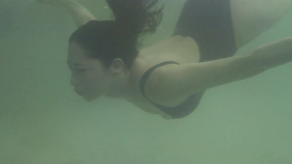 Woman swimming under water