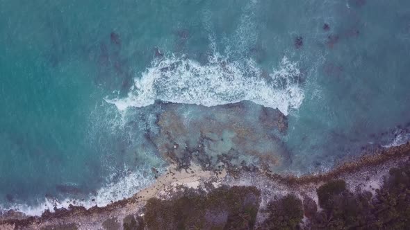 4k 24fps Drone Shoot Cenital Of The Shore With Waves And The Rocks Going Down alt