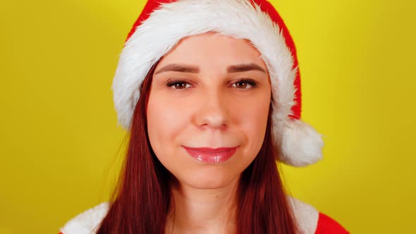 Woman in Santa Costume on Yellow Background alt