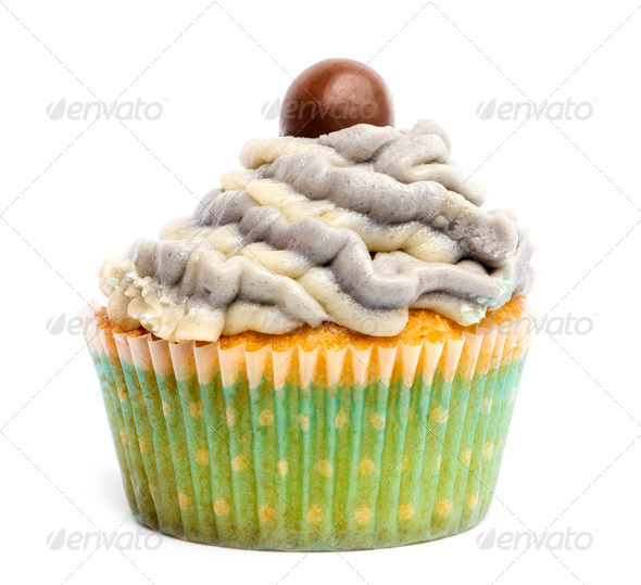 Cupcake with icing and chocolate decoration against white background in front of white background - Stock Photo - Images
