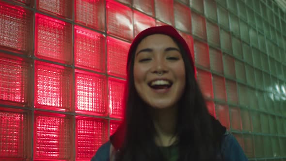 Stylish Urban Girl Smiles in Neon Light alt