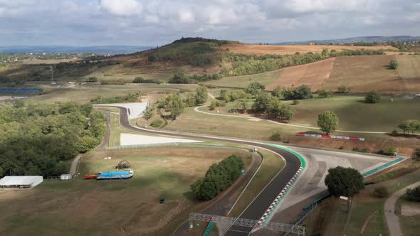 Aerial view of car racing at Hungaroring race track during endurance competition, car speeding throu