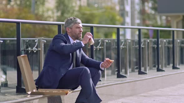 Middle-aged man having launch outside