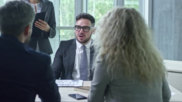 Angry Businessman Screaming at Colleagues alt