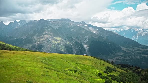Aerial drone view of nature in Georgia. Caucasus Mountains, greenery, valleys, lush clouds alt