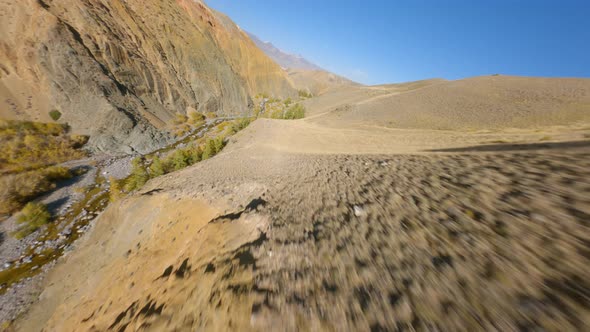 Aerial View Nature Mountain River Creek Water Flow Surrounded By Sunny Hilly Dry Formation Sun Light alt