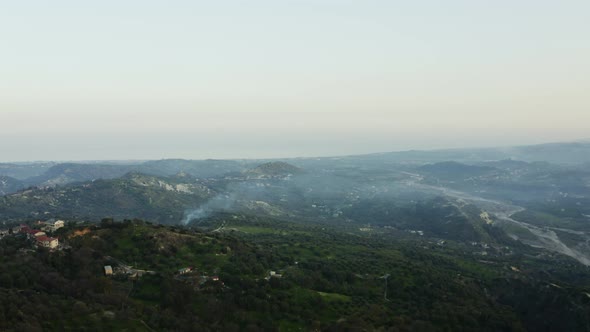 Nature in Calabria and smoke coming out chimney alt