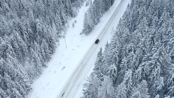 Black Car Driving on the Snow Road