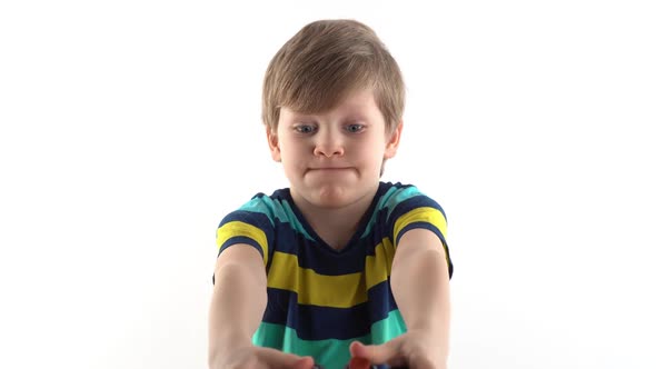 Little Boy in the Studio on a White Background Plays the Joystick in Video Games