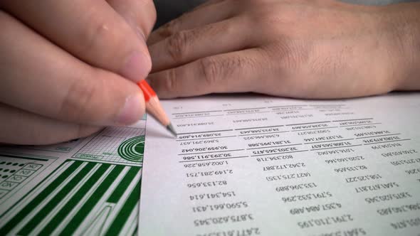Accountant analyzing business marketing data on paper dashboard at office table. alt
