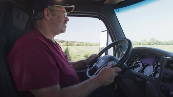 Interior shot of truck driver driving semi truck.  Fully released for commercial use.