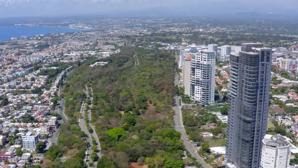 Aerial forward over Avenida Anacaona and coast, Santo Domingo city alt