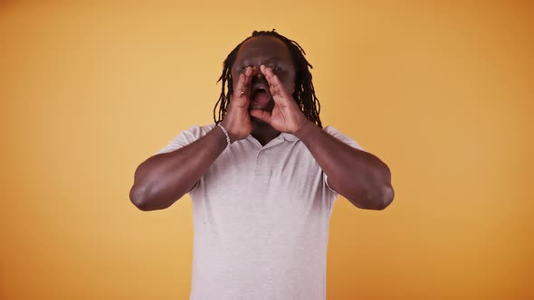 African American Black Man Makes Cupping Gesture, Calling Someone with Hands Around His Mouth  alt