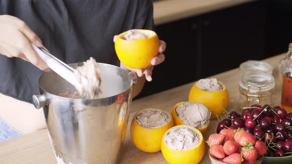 Professional Cook Puts Handmade Icecream Into Orange Peels