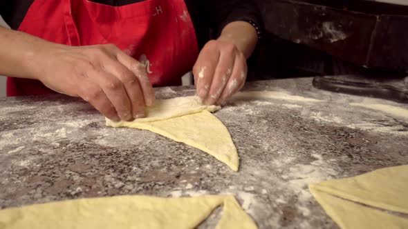 woman twisting pieces and prepare croissant alt