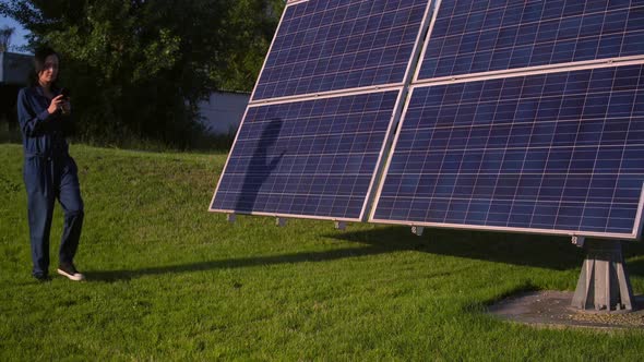 Solar Park Worker Walks Along the Array alt