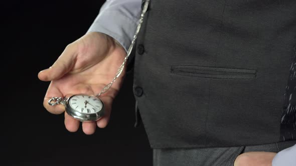 Man Pulls Out of His Pocket a Watch on a Chain That Looks at the Time. Black Background. Sound alt
