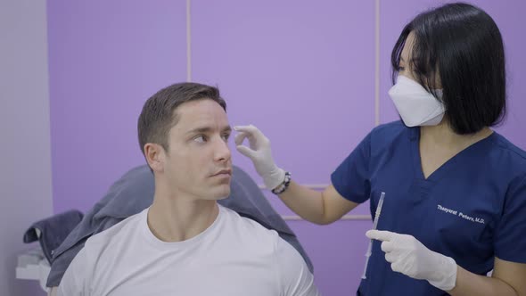 Patient and Doctor Discuss Desired Results Before Cosmetology Treatment in Bangkok alt