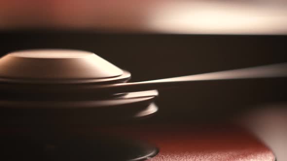 motor with a belt drive of a vinyl turntable. close-up. static frame. wooden table. alt