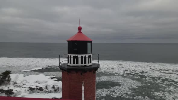 Eagle Harbor, Michigan lighthouse in winter along Lake Superior. 4k drone video. alt