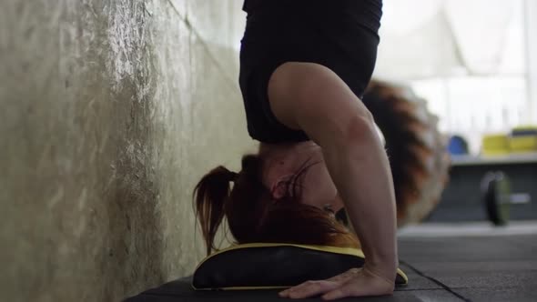 Woman Performing Handstand Push-Ups alt