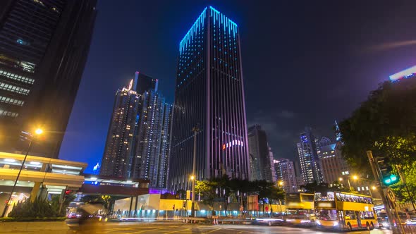 Night View Hyperlapse of Modern City Traffic Across Street with Skyscrapers alt