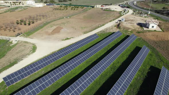 Drone pullback reveals solar panels next to road in countryside, Portugal