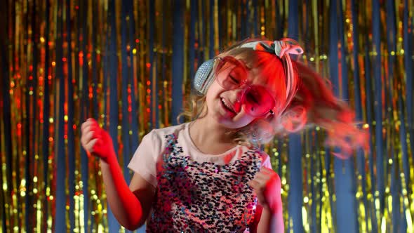 Futuristic Teen Girl Listening To Music in Headphones Dancing in Slow Motion at Disco Party Club alt