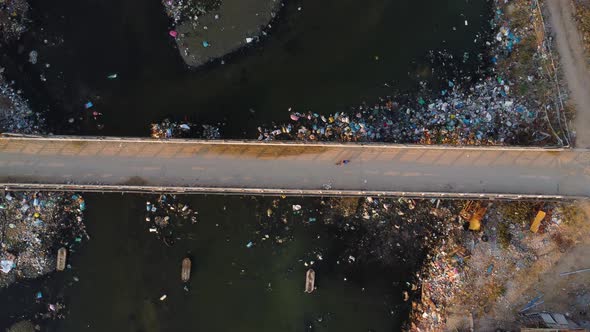 Road crossing a polluted river. Locals have problems with garbage collection. Son Hai town, near Pha alt