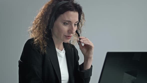 Portrait of a Woman Call Center Operator Wearing Headphones