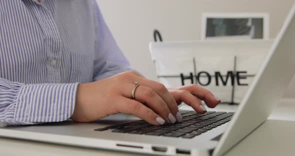 Close up female hands typing on laptop. Freelance home office. Making project.  alt