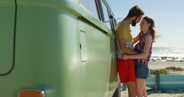 Young couple kissing near van on a sunny day 4k alt