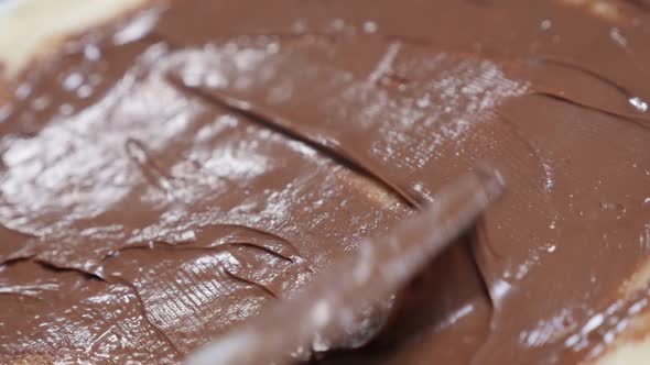 Slow motion of hazelnut creme spread over pancake   and rolling  1920X1080 HD tilting footage - Choc alt