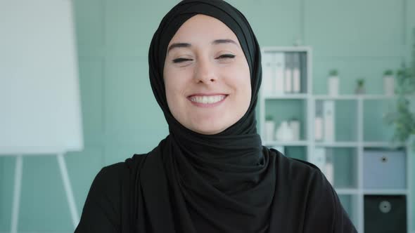 Female Happy Face Closeup Portrait Indoors Islamic Muslim Arabian Woman Girl in Black Hijab Nods alt