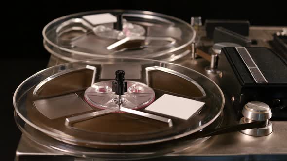 Vintage Reel to Reel tape recorder playing music close up of reel alt