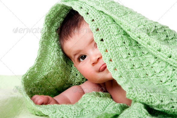 Cute happy baby between green blankets - Stock Photo - Images