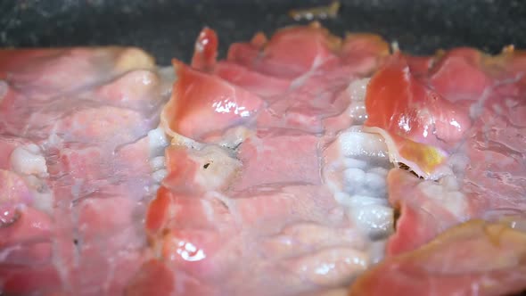 Smoked Bacon Being Fried