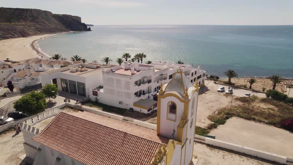 Church of Nossa Senhora da Luz overlooking the Algarve Coastline - Aerial alt