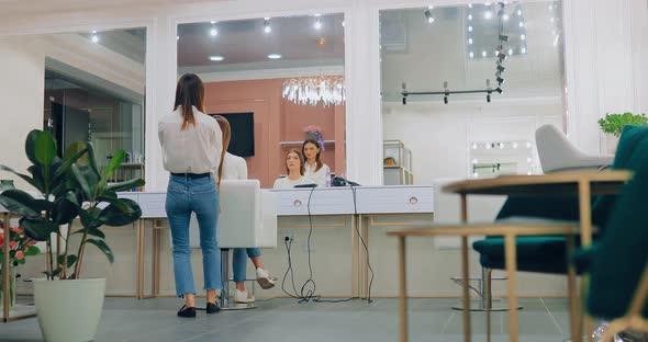 Hairdresser is Applying Hair Products to a Beautiful Girl in a Modern Beauty Salon alt