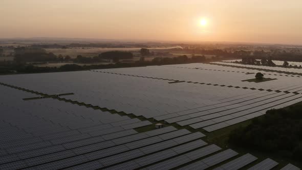 Aerial view over solar farm at sunrise