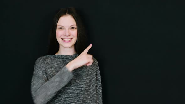 Woman Is Smiling and Shows By Finger Up Right