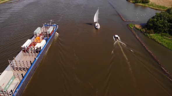 Yacht, Sailboat And Barge With Shipping Container Sailing Across The Oude Maas In Netherlands. - aer alt