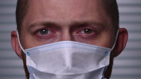 Close-up of young Caucasian man wearing a mask. Stay safe in the virus epidemic alt