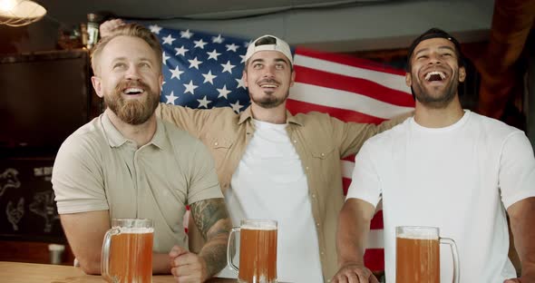 Soccer Fans Celebrating Victory of Team in Sports Bar alt
