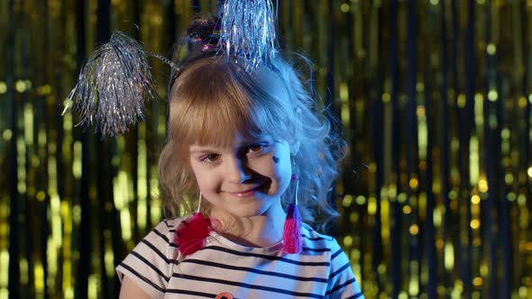 Portrait of Trendy Stylish Girl Looking at Camera Smiling Child Kid in Neon Light at Disco Club alt