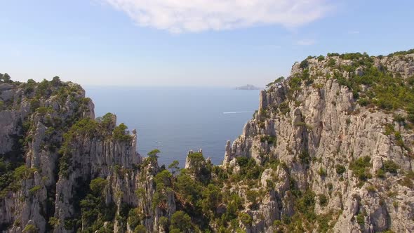 Aerial travel drone view of clear green water, cliffs of Cassis, Mediterranean Sea, Southern France. alt