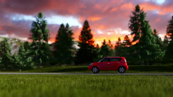 Red Car On The Road At Sunset